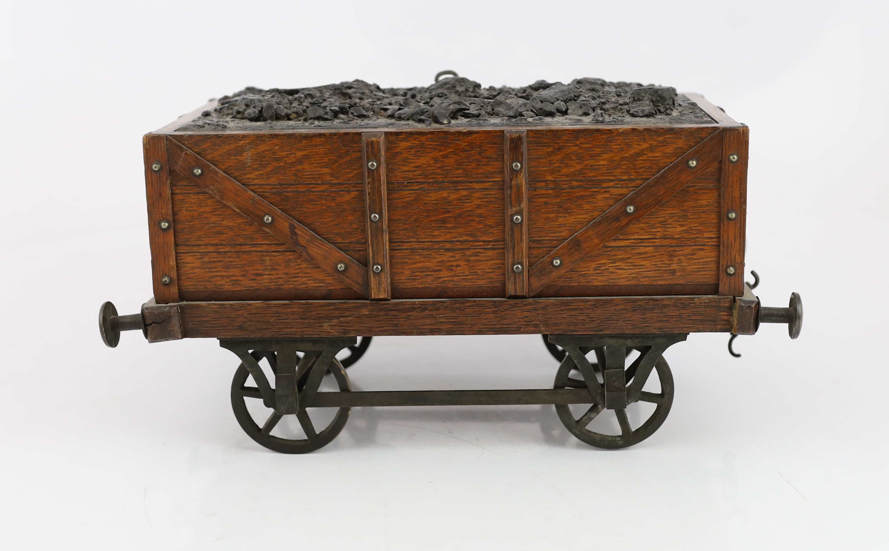 An Edwardian novelty oak smoker's compendium modelled as a railway tender, 34cm wide, 17cm deep, 17cm high